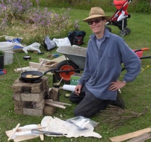 Ellis cooks on the rocket stove